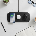 3-in-1 wireless charging pad on white desk charging smartphone, earbuds and smartwatch simultaneously